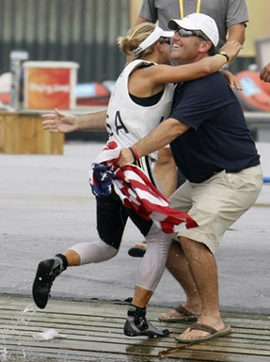 Anna Tunnicliffe (L) of the U.S.celebrates with U.S. team leader Dean Brenner.
