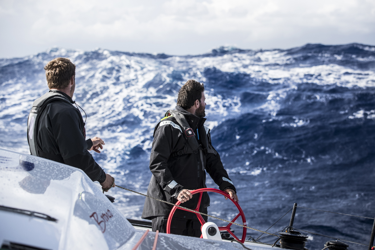Rome Kirby and Shannon Falcone stare down a 7 meter wave while sailing the F4 race yacht from New York to Bermuda with Team Falcon on November 7, 2016